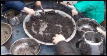 Hands in mud kitchen